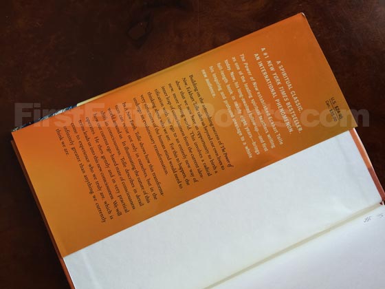 Picture of dust jacket where original $24.95 price is found for A New Earth. 